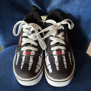 Like new heelys skeleton wheeled shoe. Worn once! Youth size 6